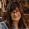 Woman with bangs and glasses smiling