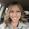 Woman smiles in car