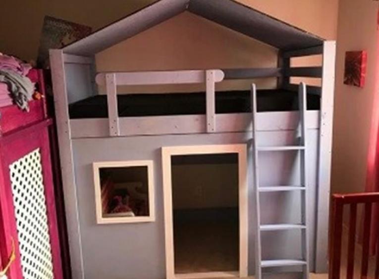 Small playhouse made out of wood.