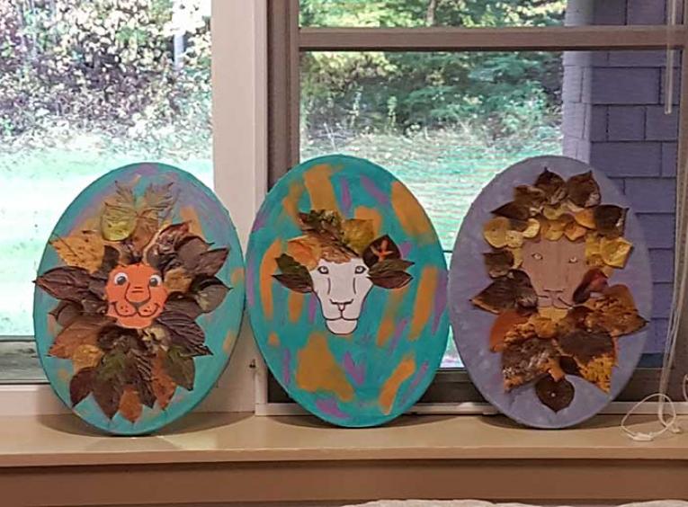 3 oval crafts that depict lions on a windowsill