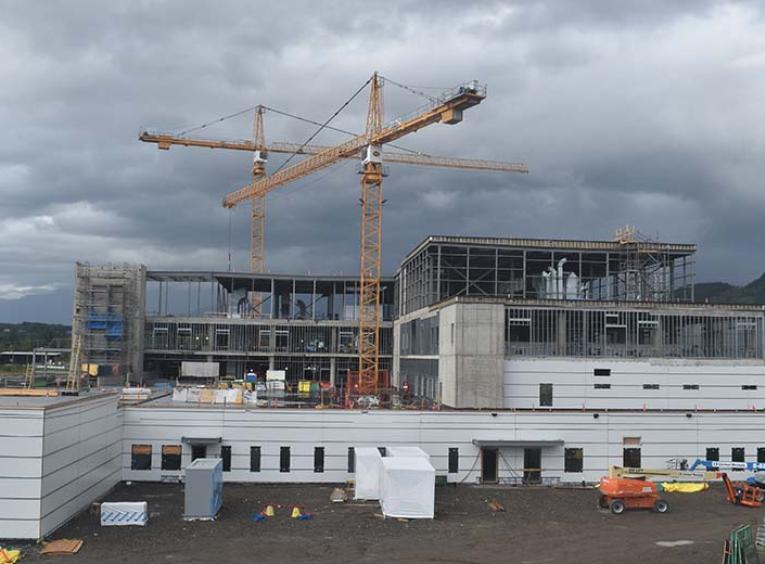 a shot of the hospital under construction with a large yellow crane in the background